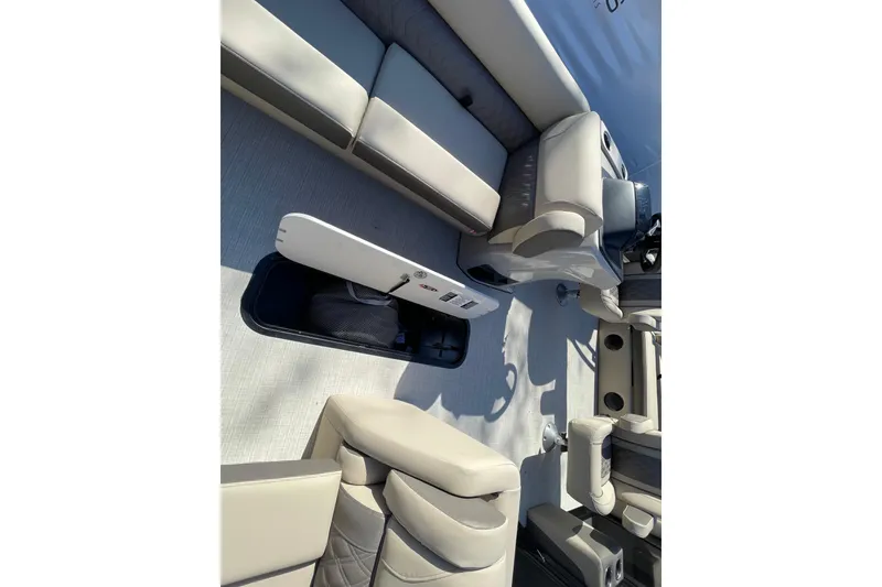 Slide: The Image of 2026 Harris Cruiser 250 interior with spacious seating and storage compartment. - 11