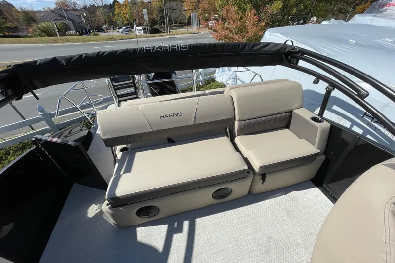 Slide: The Image of 2026 Harris Cruiser 250 boat interior with beige seating and cup holders. - 16