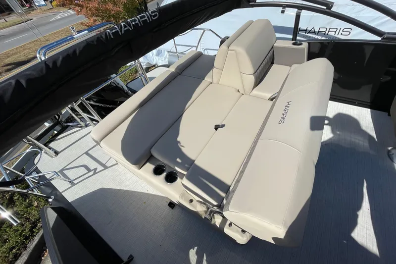 Slide: The Image of 2026 Harris Cruiser 250 boat interior with beige seating and cup holders. - 18