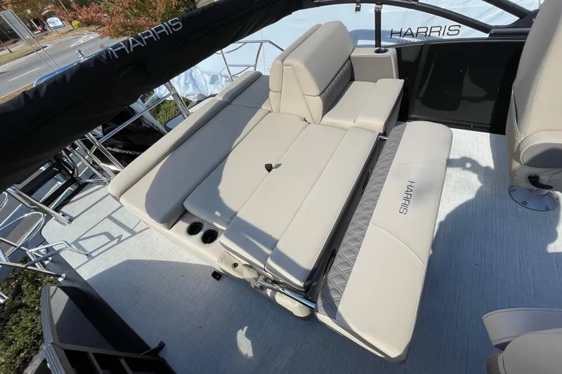 Slide: The Image of 2026 Harris Cruiser 250 boat interior with beige seating and cup holders. - 19