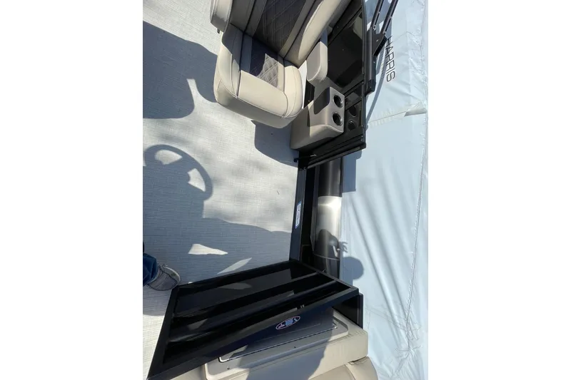 Slide: The Image of Interior of 2026 Harris Cruiser 250 boat with seating and cup holders. - 23