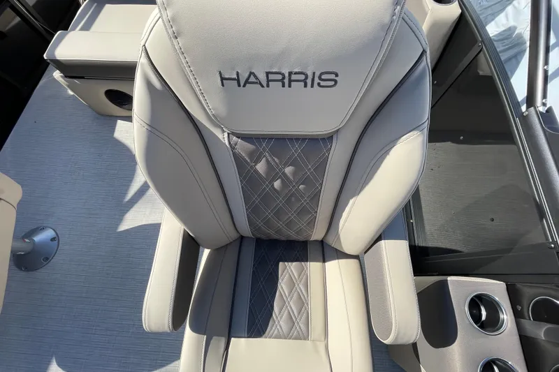Slide: The Image of 2026 Harris Cruiser 250 boat seat with elegant stitching and cup holders. - 24