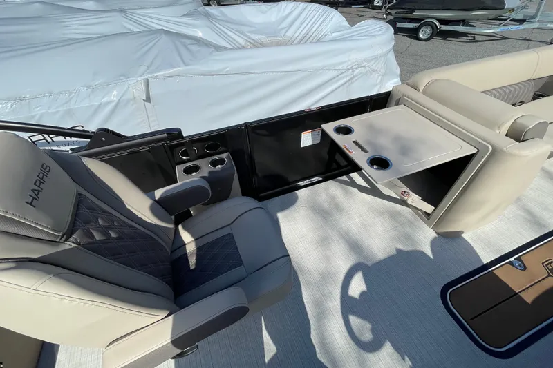 Slide: The Image of 2026 Harris Cruiser 250 boat interior with luxurious seating and cup holders. - 26