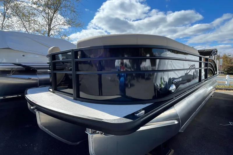 Slide: The Image of 2026 Harris Cruiser 250 pontoon boat under a partly cloudy sky. - 3