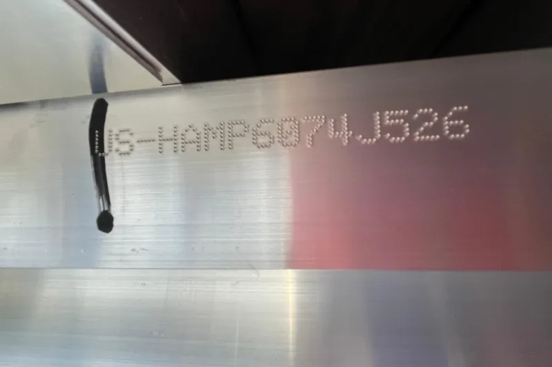 Slide: The Image of 2026 Harris Cruiser 250 hull identification number on metal surface. - 5