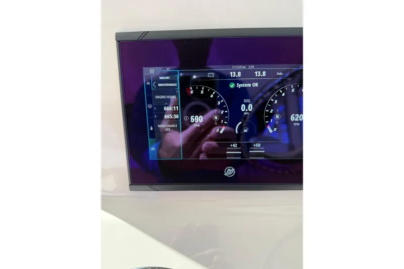 Slide: The Image of Dashboard display of a 2019 Boston Whaler 315 Conquest boat showing engine metrics. - 12