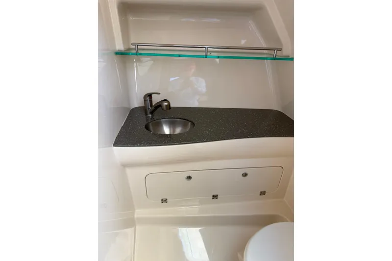 Slide: The Image of 2019 Boston Whaler 315 Conquest bathroom with sink, countertop, and storage cabinet. - 19