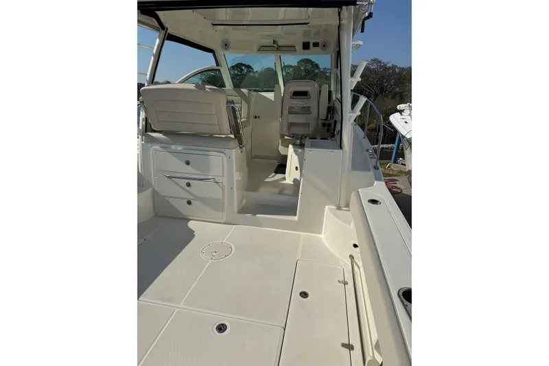 Slide: The Image of 2019 Boston Whaler 315 Conquest boat interior, featuring seating and storage compartments. - 8