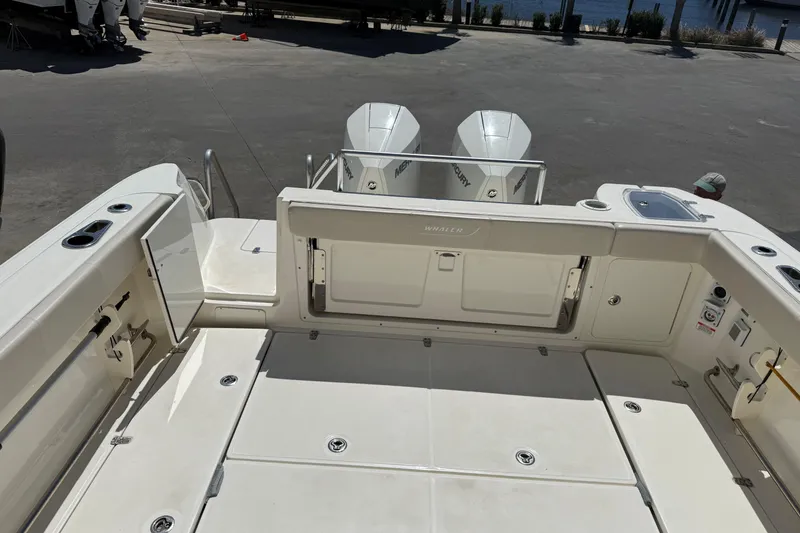 Slide: The Image of 2019 Boston Whaler 315 Conquest boat deck with twin Mercury engines. - 9