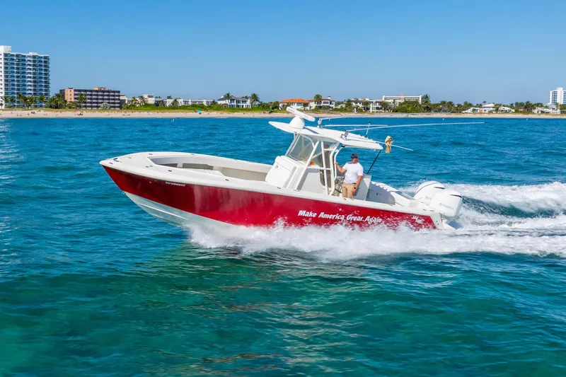 The Image of 2016 SeaVee 340Z boat cruising on blue ocean near coastline. - 0