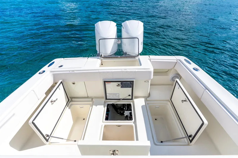 Slide: The Image of 2016 SeaVee 340Z boat deck with open storage compartments and twin engines. - 15