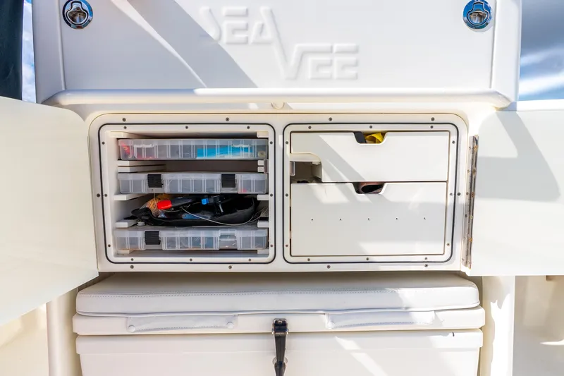 Slide: The Image of Storage compartments on a 2016 SeaVee 340Z boat, featuring organized tackle boxes. - 17