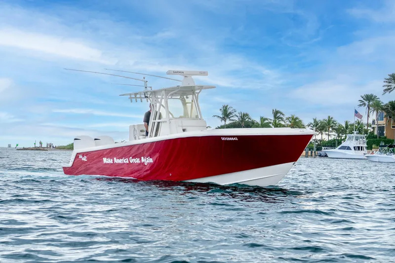 Slide: The Image of 2016 SeaVee 340Z boat with red hull, "Make America Great Again" text, on water. - 2