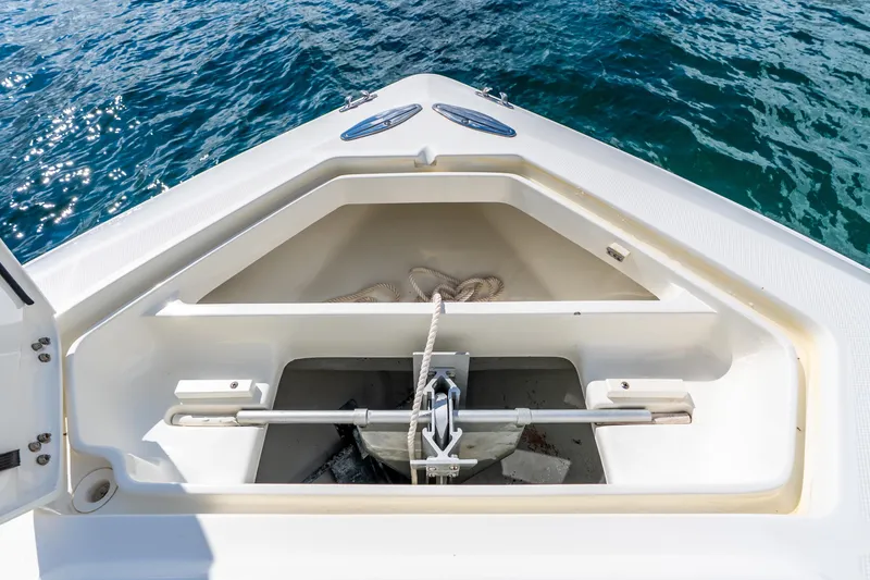 Slide: The Image of 2016 SeaVee 340Z boat anchor compartment with open hatch, near blue ocean water. - 23