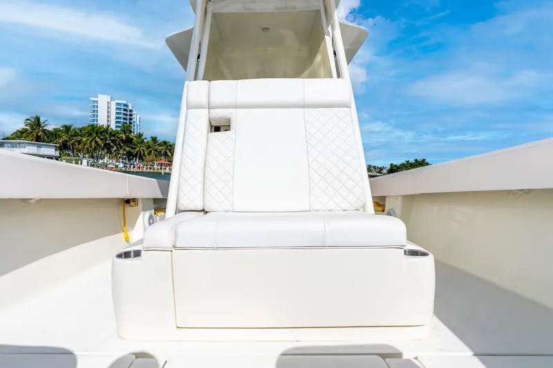 Slide: The Image of 2016 SeaVee 340Z boat with white seating, coastal backdrop, and blue sky. - 25