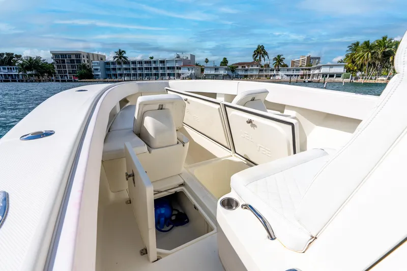 Slide: The Image of 2016 SeaVee 340Z boat interior with open storage compartments, docked near waterfront buildings. - 26