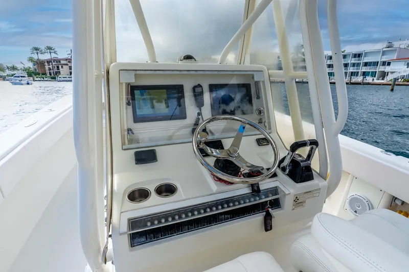 Slide: The Image of 2016 SeaVee 340Z boat dashboard with steering wheel and navigation equipment. - 29