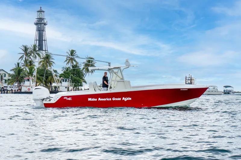 Slide: The Image of 2016 SeaVee 340Z boat with "Make America Great Again" slogan, near a lighthouse and palm trees. - 3