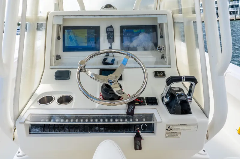 Slide: The Image of Control panel of a 2016 SeaVee 340Z boat with steering wheel and navigation screens. - 30