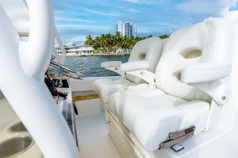 Slide: The Image of Luxurious white seating on 2016 SeaVee 340Z boat with scenic waterfront view. - 31
