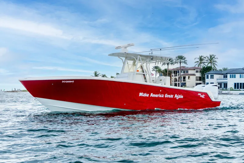 Slide: The Image of 2016 SeaVee 340Z boat with red hull, "Make America Great Again" text, on water. - 33