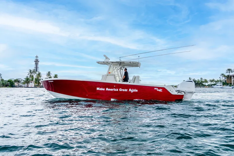 Slide: The Image of 2016 SeaVee 340Z boat with "Make America Great Again" slogan on water, lighthouse in background. - 34