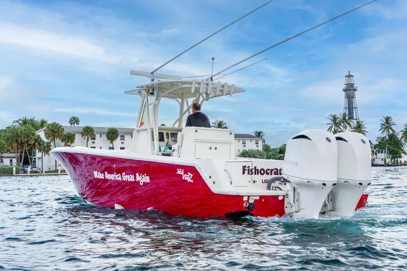 Slide: The Image of 2016 SeaVee 340Z boat with red hull and twin Yamaha engines on water. - 36