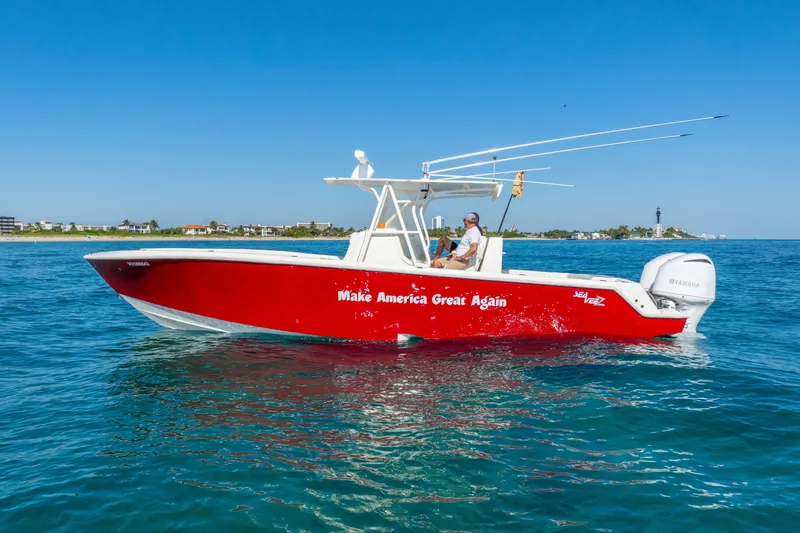 Slide: The Image of 2016 SeaVee 340Z boat in water, red hull, "Make America Great Again" text. - 42