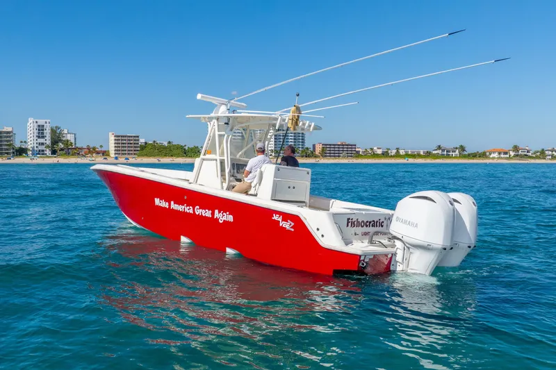 Slide: The Image of 2016 SeaVee 340Z boat with red hull, "Make America Great Again" text, on blue ocean near coastline. - 43