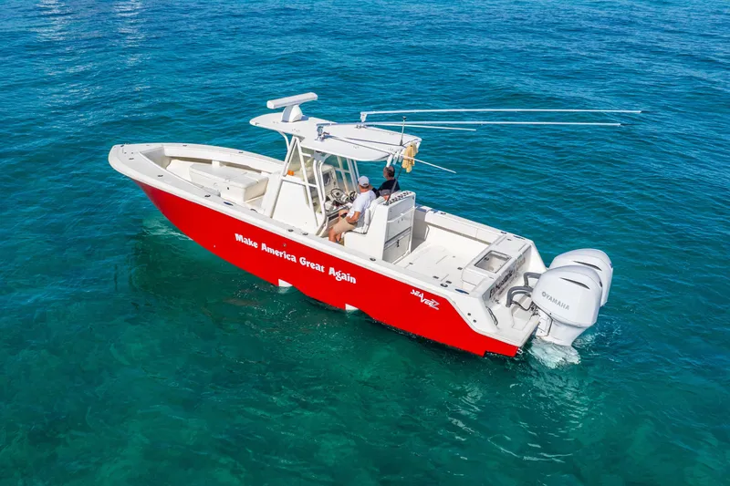 Slide: The Image of 2016 SeaVee 340Z boat with red hull, "Make America Great Again" text, on clear blue water. - 47