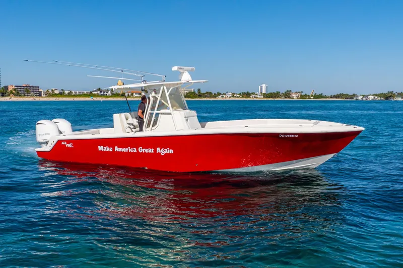 Slide: The Image of 2016 SeaVee 340Z boat with red hull and slogan, cruising on clear blue water. - 51