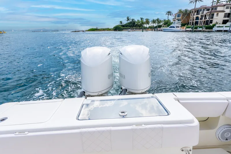 Slide: The Image of 2016 SeaVee 340Z boat with dual Yamaha engines cruising on a scenic waterway. - 8