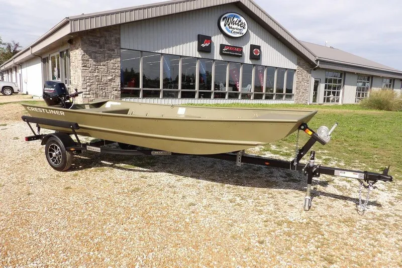 Slide: The Image of 2026 Crestliner 1648M CR Jon boat on trailer outside marine center. - 19