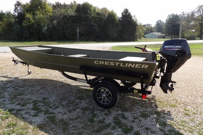 Slide: The Image of 2026 Crestliner 1648M CR Jon boat with Mercury motor on a trailer, parked outdoors. - 2