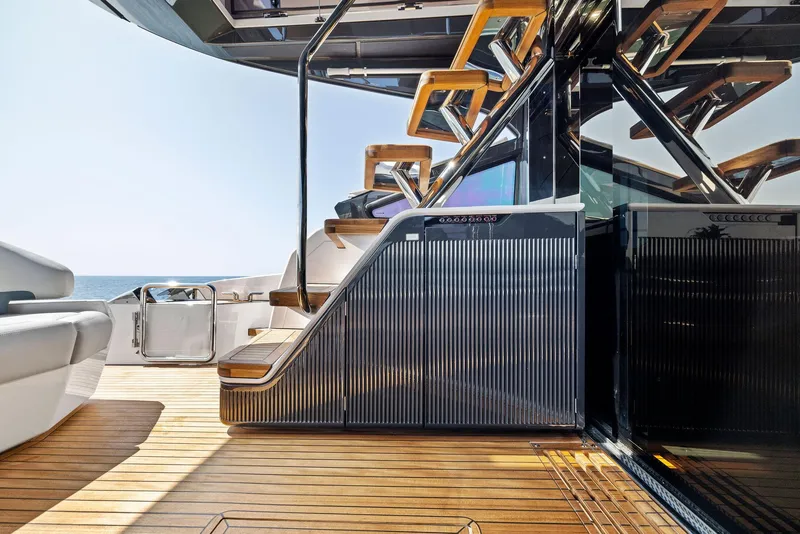 Slide: The Image of Luxury yacht Fairline Phantom 65, 2024 model, featuring elegant wooden deck and modern staircase design. - 10