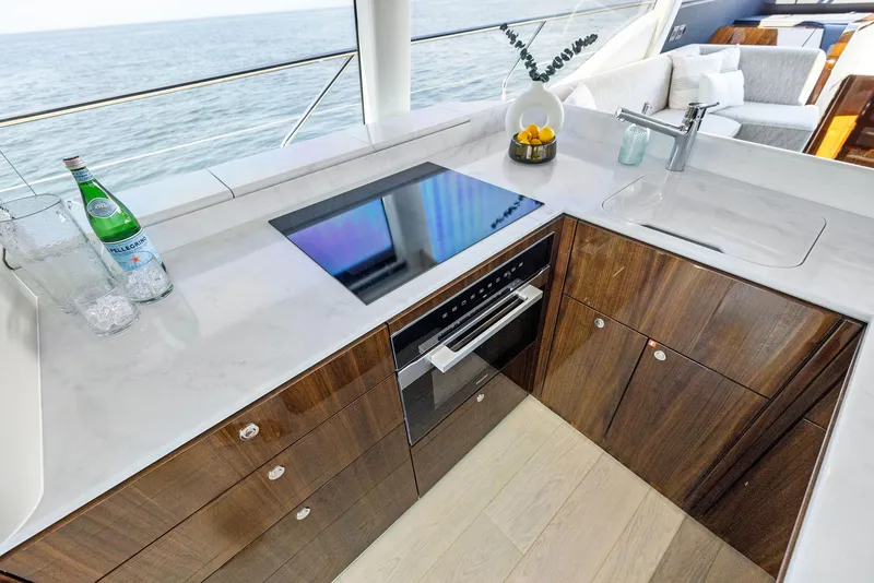 Slide: The Image of 2024 Fairline Phantom 65 yacht helm with modern dashboard and steering wheel. - 17