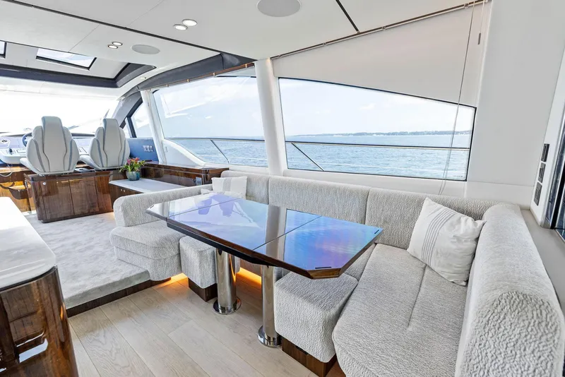 Slide: The Image of Luxurious interior of 2024 Fairline Phantom 65 yacht with plush seating and elegant wood finishes. - 18