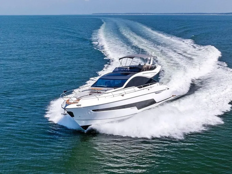 Slide: The Image of 2024 Fairline Phantom 65 yacht cruising on open water, showcasing sleek design and luxury features. - 2