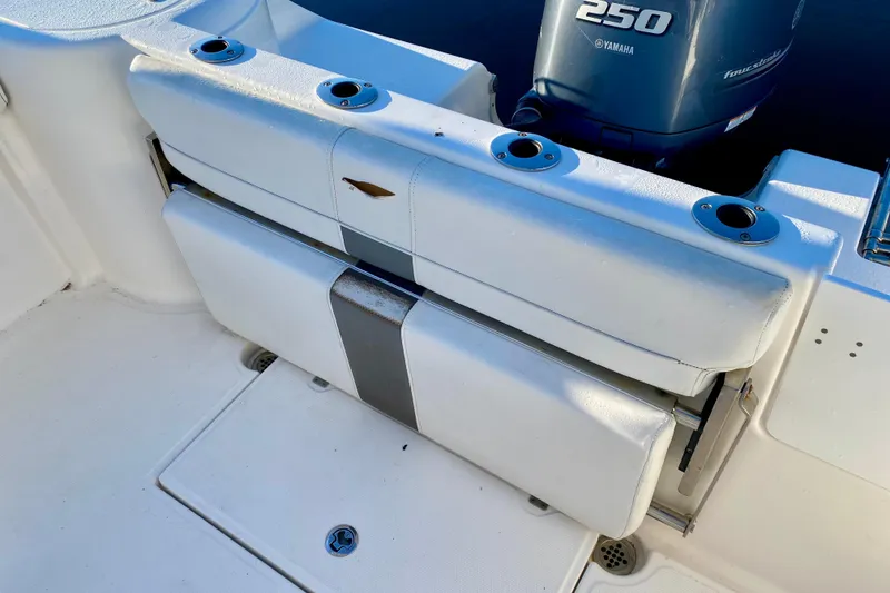 Slide: The Image of 2013 Tidewater 230 CC Adventure boat with Yamaha 250 engine, featuring rod holders. - 2