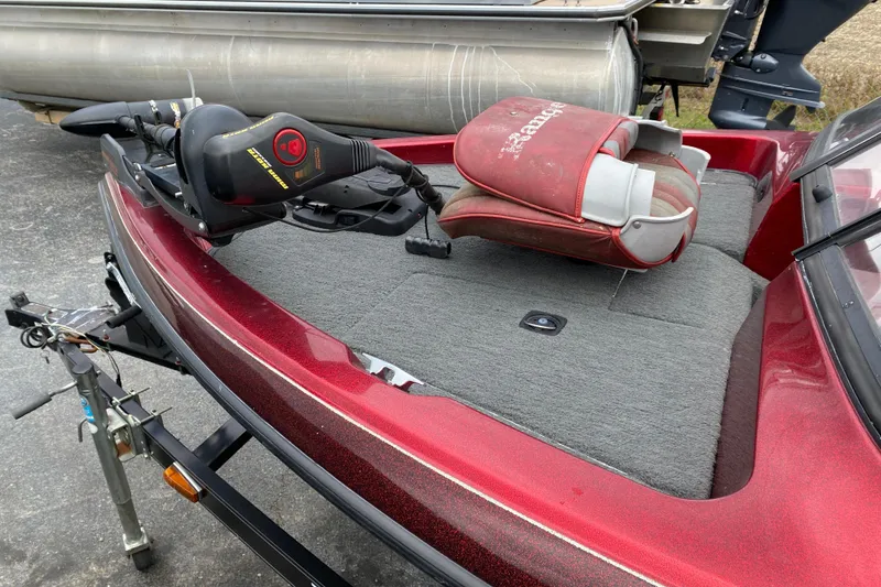Slide: The Image of 1999 Ranger R77 Sport boat with red seat and trolling motor on trailer. - 12