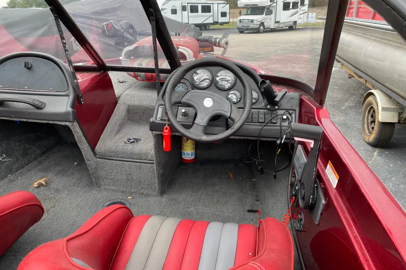 Slide: The Image of Interior of a 1999 Ranger R77 Sport boat with steering wheel and dashboard controls. - 23