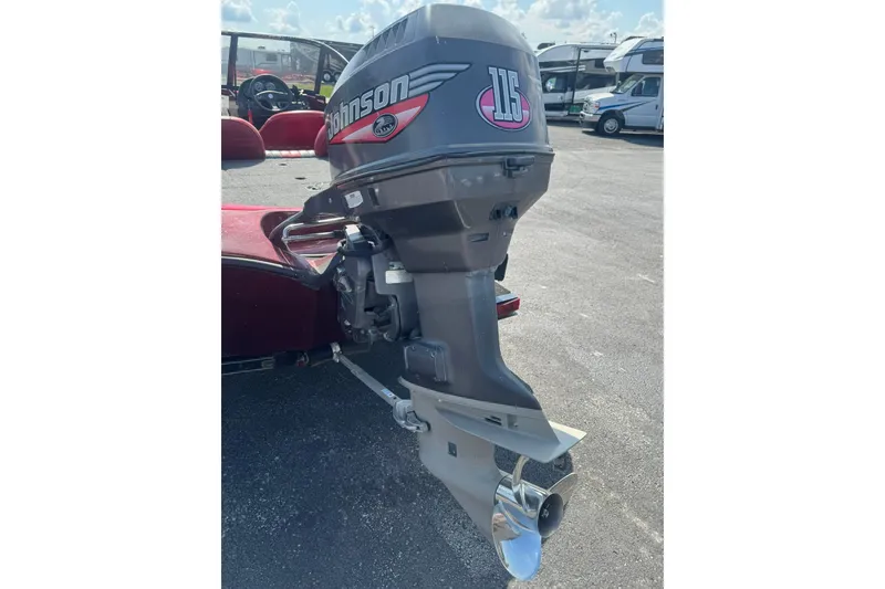Slide: The Image of 1999 Ranger R77 Sport with Johnson 115 outboard motor in a parking lot. - 27