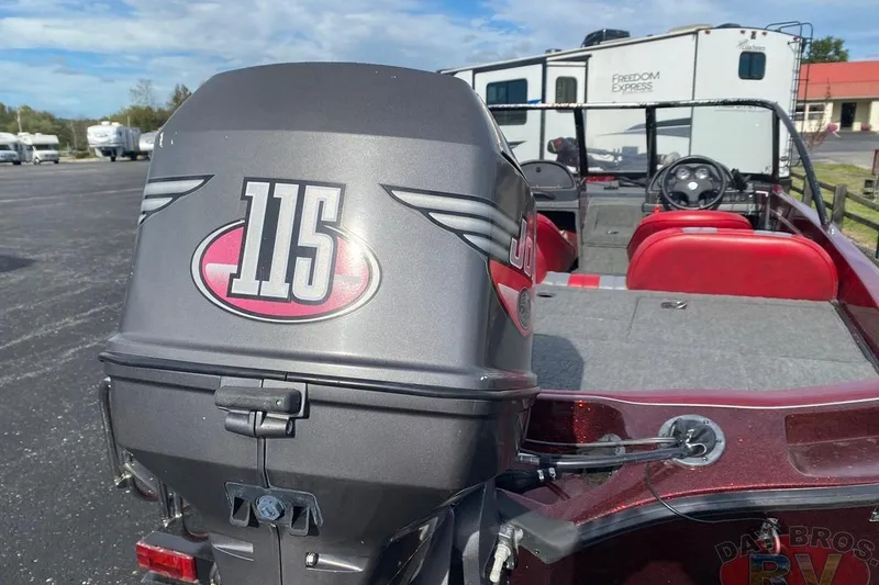 Slide: The Image of 1999 Ranger R77 Sport boat with 115 horsepower engine, parked near RVs. - 6