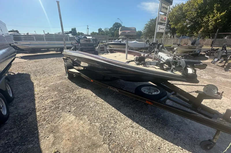 Slide: The Image of 1998 Charger 186 VF boat on trailer in sunny outdoor setting. - 10