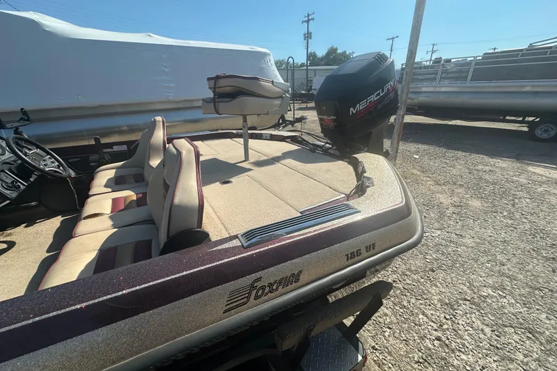 Slide: The Image of 1998 Charger 186 VF boat with Mercury engine, parked outdoors. - 13