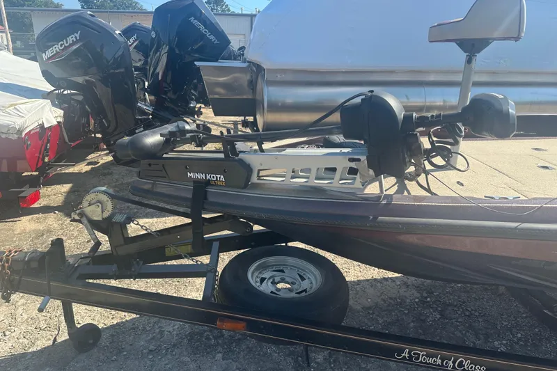 Slide: The Image of Boat trailer with Minn Kota Ultrex motor, Mercury engines, and Charger 186 VF, 1998 model. - 4