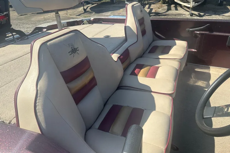 Slide: The Image of 1998 Charger 186 VF boat interior with beige and maroon seats, steering wheel visible. - 7
