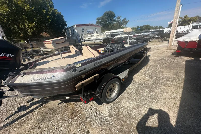 Slide: The Image of 1998 Charger 186 VF boat with "A Touch of Class" text, parked outdoors. - 9