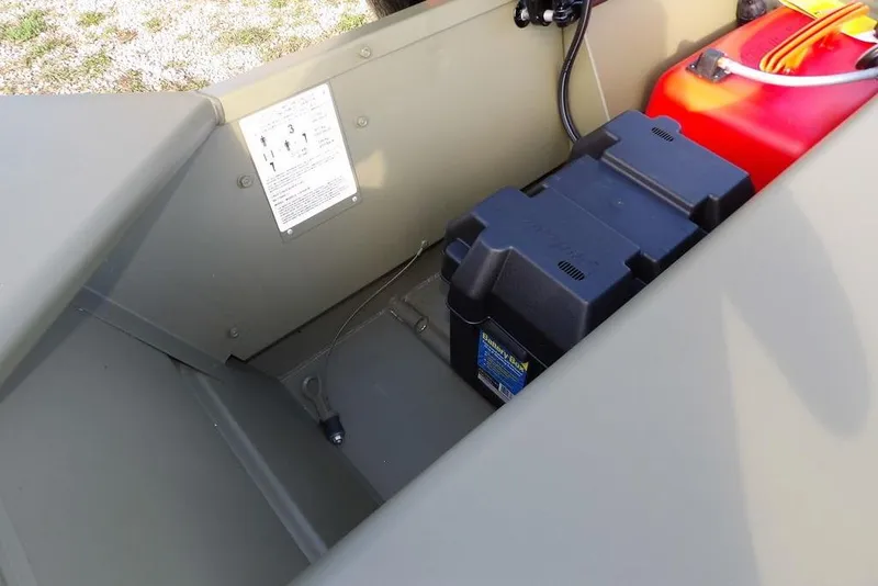 Slide: The Image of Interior of 2026 Crestliner 1648M CR Jon boat showing battery and fuel tank. - 11