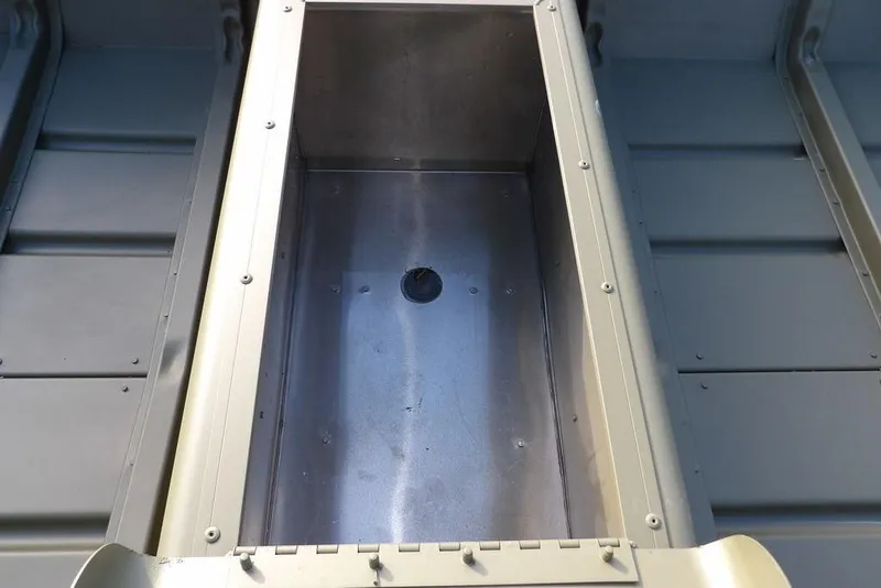 Slide: The Image of 2026 Crestliner 1648M CR Jon boat interior, featuring a central storage compartment. - 12